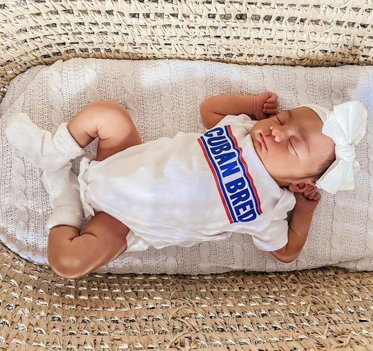 Baby wearing a Martha of Miami Cuban Bred onesie