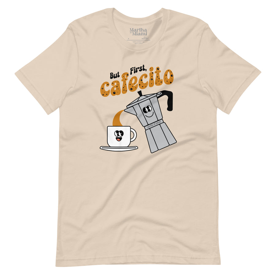 But First, Cafecito men's t-shirt with smiling moka pot pouring into cafecito cup, cream t-shirt