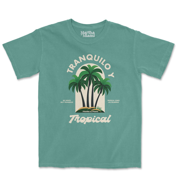 Light green t-shirt with the text 'Tranquilo y Tropical' and an illustration of three palm trees. The design also includes the phrases 'me siento muy tranquilo' and 'tropical como las palmeras'.