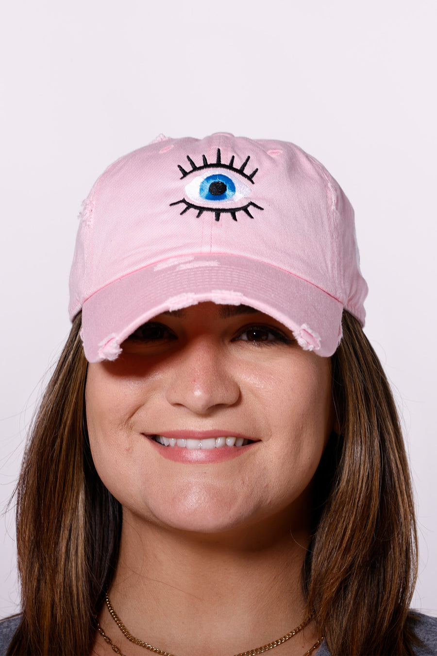 Martha of Miami wearing denim Mal de Ojo Hat for Protection Evil Eye Hat Gorra de Mal de Ojo