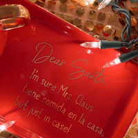 an image of a red dish plate that says dear santa, I'm sure Mrs. Claus tiene comida en la cada but just in case!