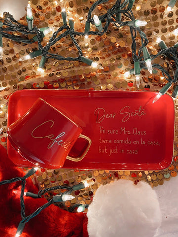 an image of a red coffee mug and a red dish plate that says dear santa, I'm sure Mrs. Claus tiene comida en la cada but just in case!