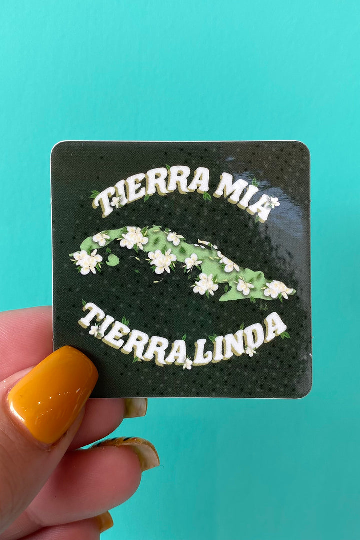 an image of a green sticker with the graphic image of the island of cuba adorned with mariposas, the island's national flower